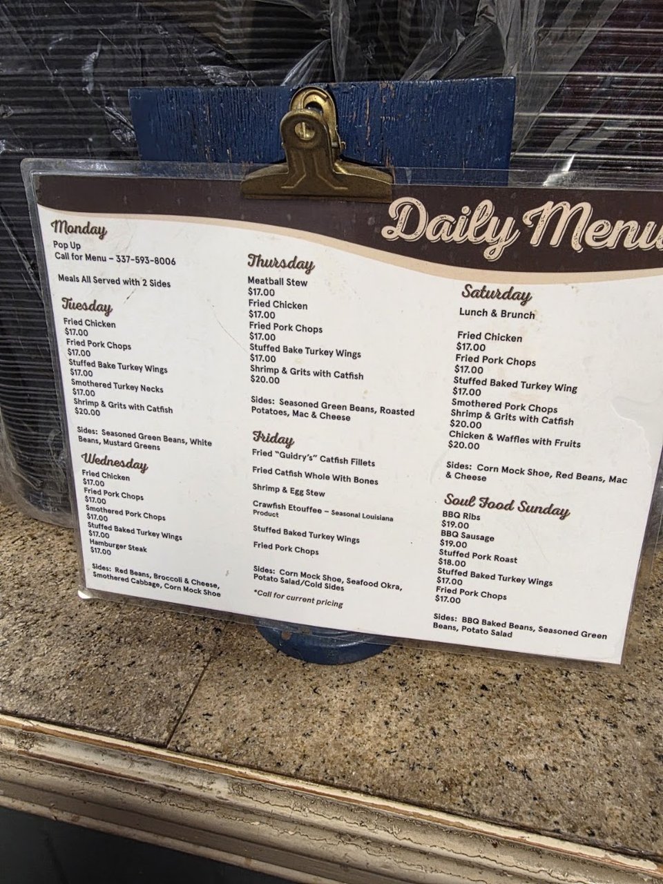 Menu board showing turkey wings and sides.